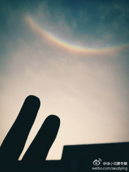 申城微笑彩虹实为罕见的幻日弧光(图片来自新浪微博网友) 申城微笑彩虹实为罕见的幻日弧光(图片来自新浪微博网友)